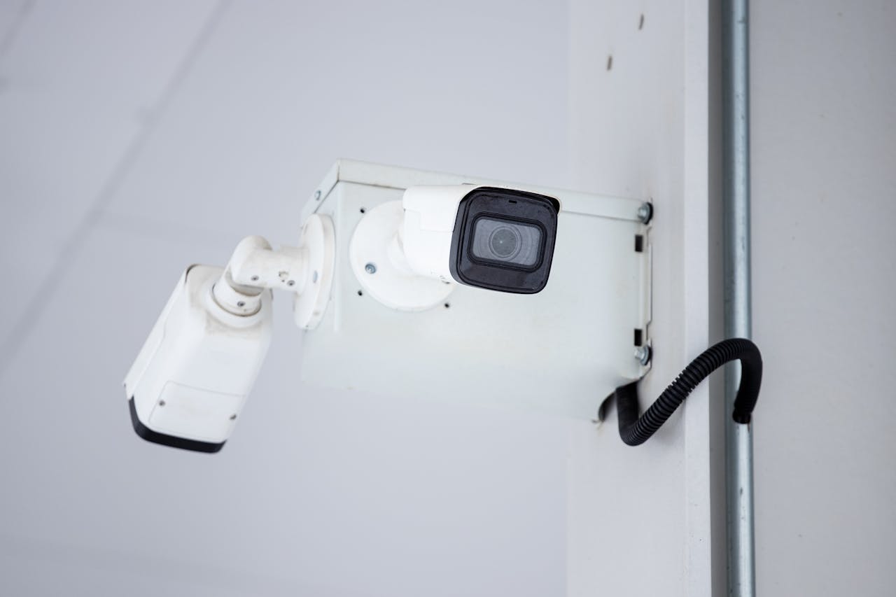 about-img A close-up shot of a modern, mounted surveillance camera highlighting security and surveillance.