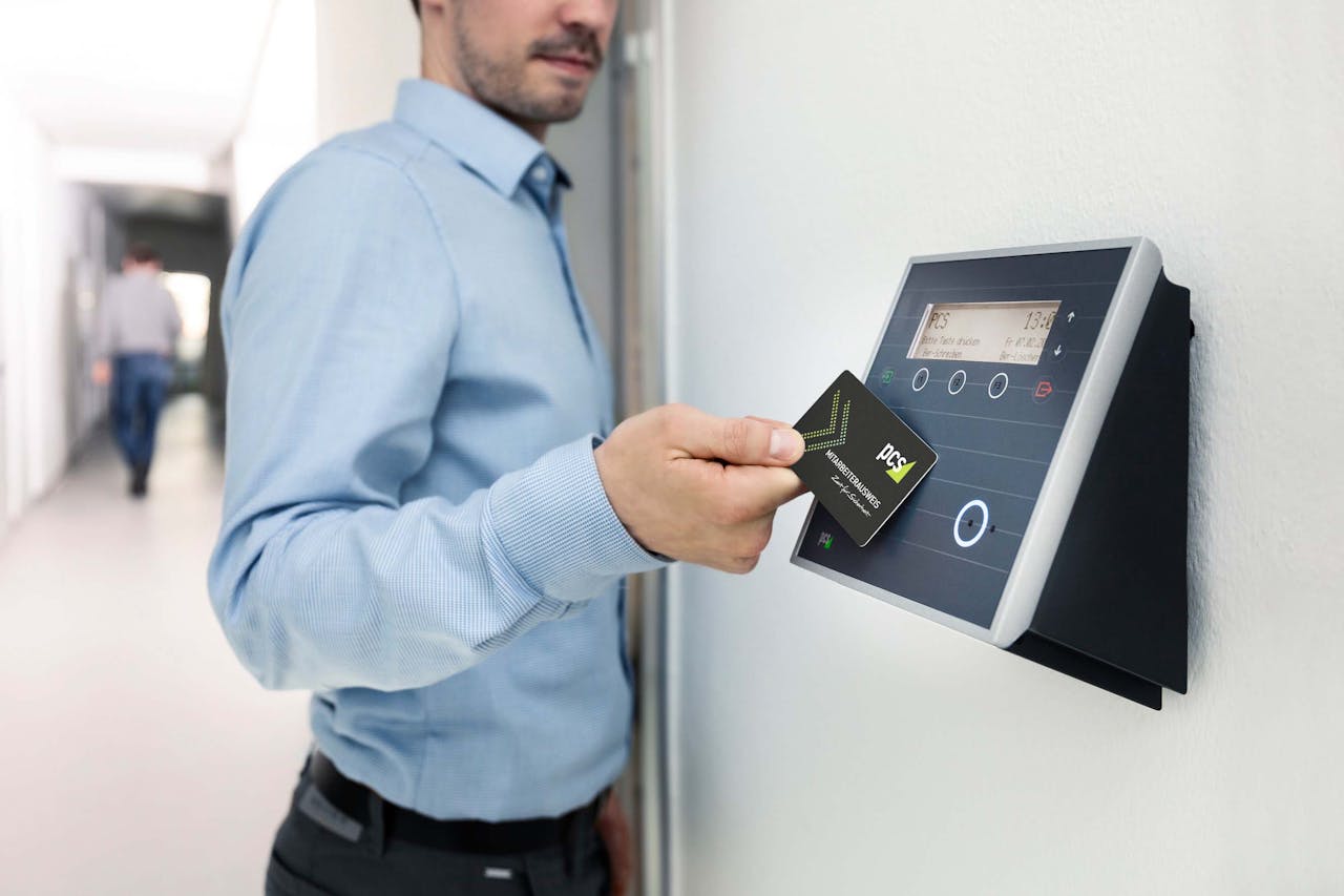 gallery-4 Businessman uses RFID card reader for secure office access, enhancing workplace security.