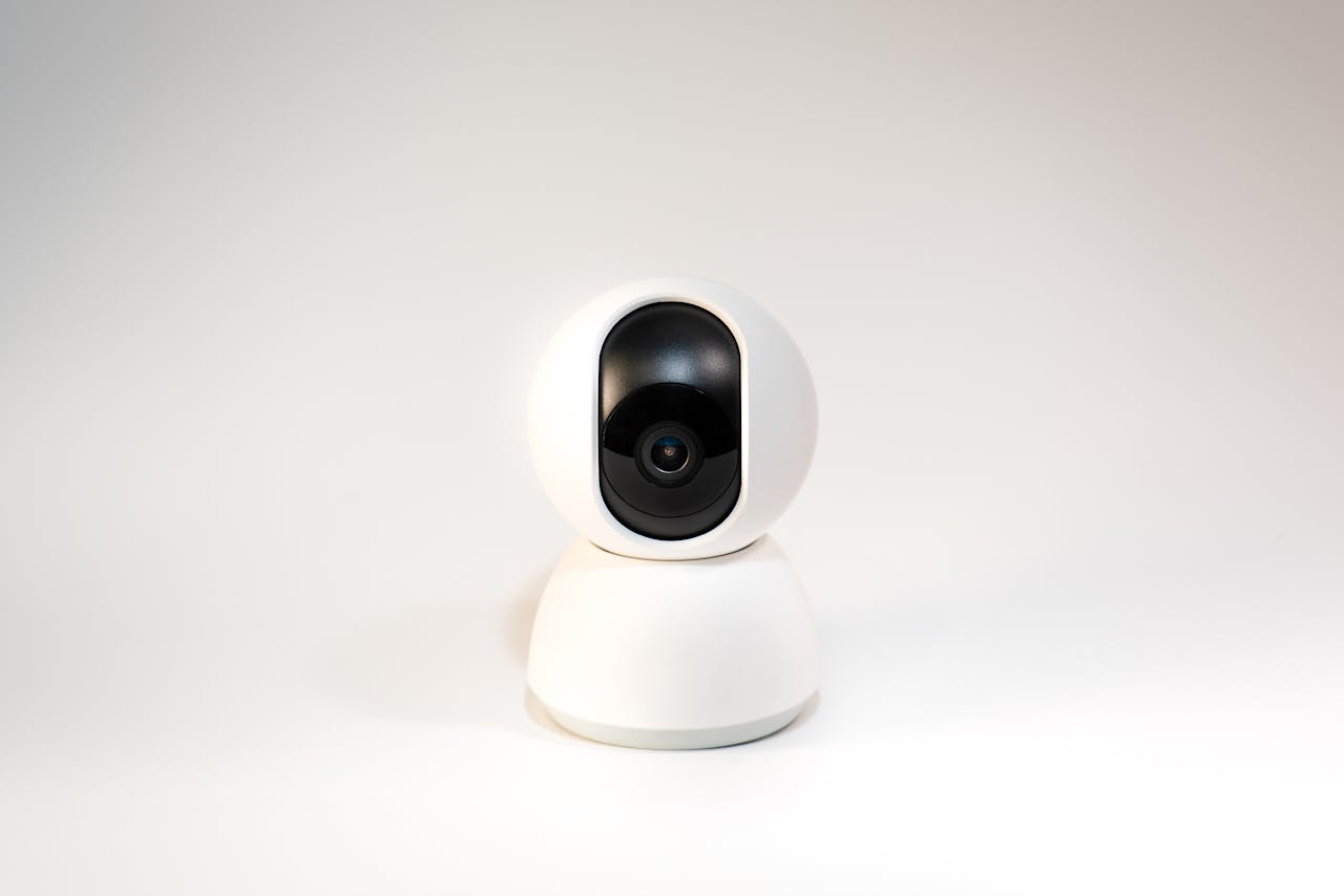 hero-img-02 A sleek, white minimalistic smart home security camera on a white background.