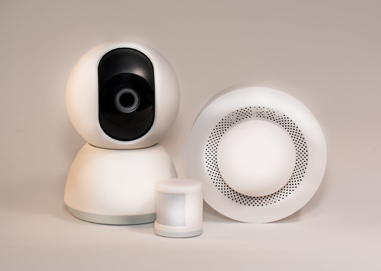 our-experience A collection of modern smart home security devices featuring cameras and sensors.